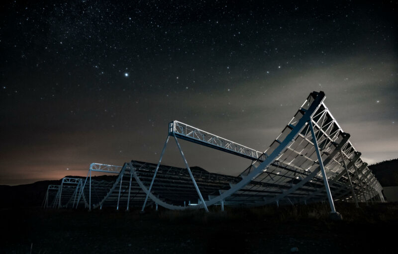 Image of a radio telescope against the night sky.