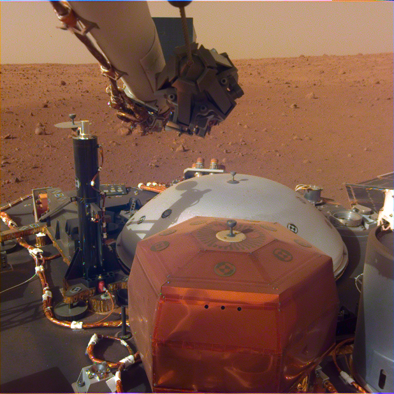 Image of metal hardware on a dusty, reddish landscape.