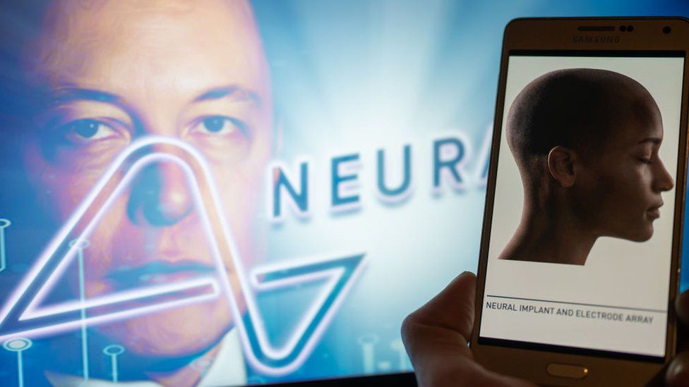 Neuralink logo displayed on mobil with founder Elon Musk seen on screen in the background, in Brussels on 4 December 2022.